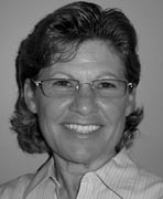 A black and white photo of a woman wearing glasses.