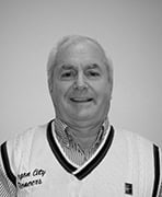 A black and white photo of an older man wearing a vest.