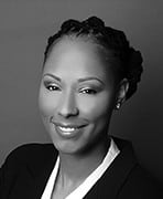 A black and white photo of a woman in a business suit.