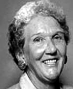 A black and white photo of an older woman smiling.