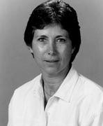 A black and white photo of a woman in a white shirt.