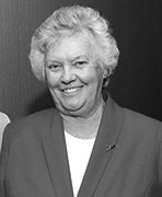 A black and white photo of an older woman smiling.