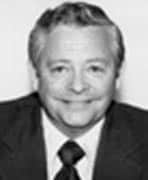 A black and white photo of a man in a suit.