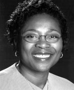 A black and white photo of a woman wearing glasses.