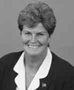 A black and white photo of a woman smiling.