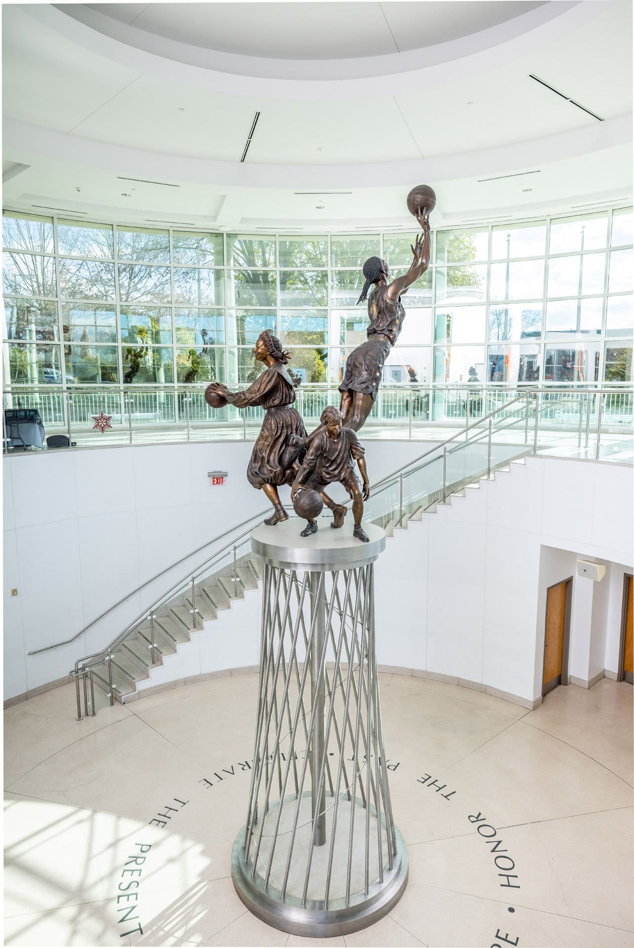 A berenson trophy statue of a basketball player on top of a staircase. A berenson trophy statue of a basketball player on top of a staircase.