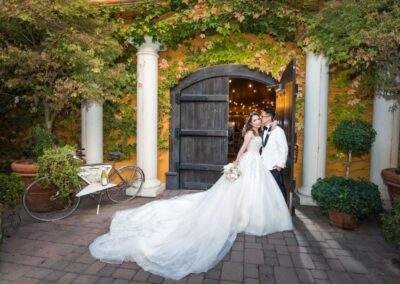 CineCrown wedding photo bride and groom posing in front of a yellow door.