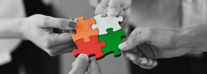 Puzzle pieces connecting representing business solutions and teamwork.