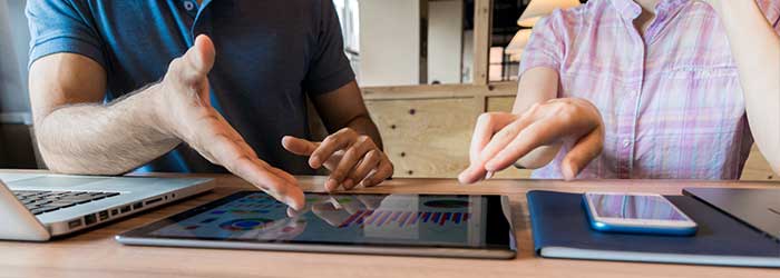 Expert business collaboration on digital devices in a modern workspace.