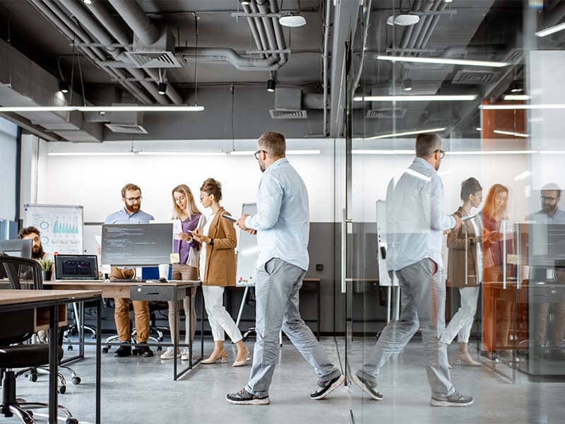 Business team collaborating in modern office for West X Business Solutions.