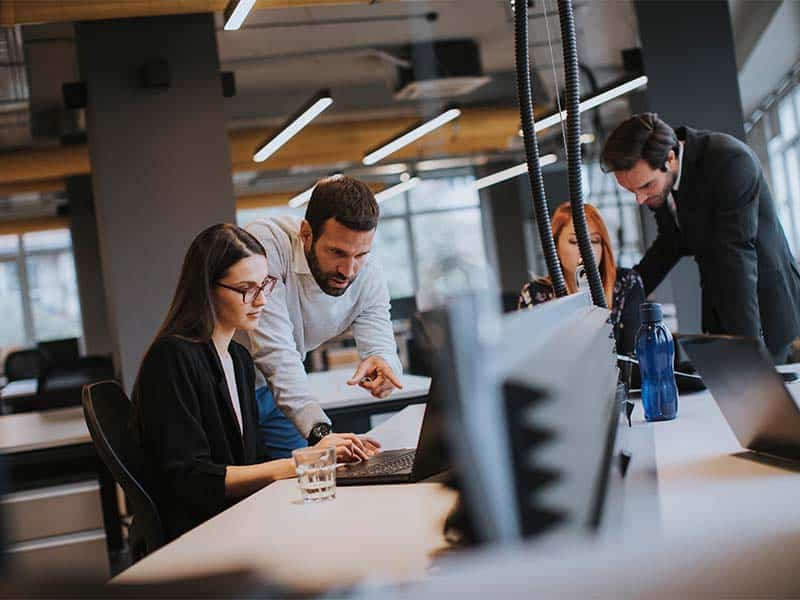 Innovative business solutions team collaborating in modern office environment.