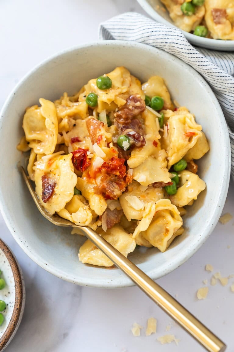 cheese tortellini carbonara with bacon in glossy cream sauce