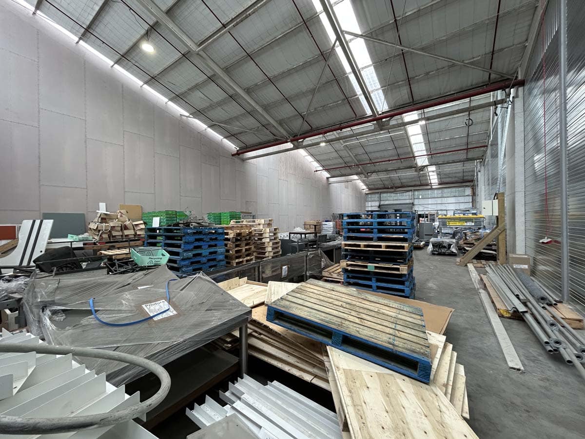 Interior view of White Lion warehouse with pallets and construction materials.