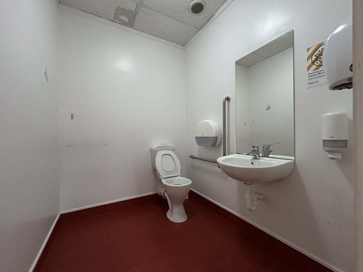 Accessible commercial bathroom with toilet and sink at 8 Mohuia Crescent 1.