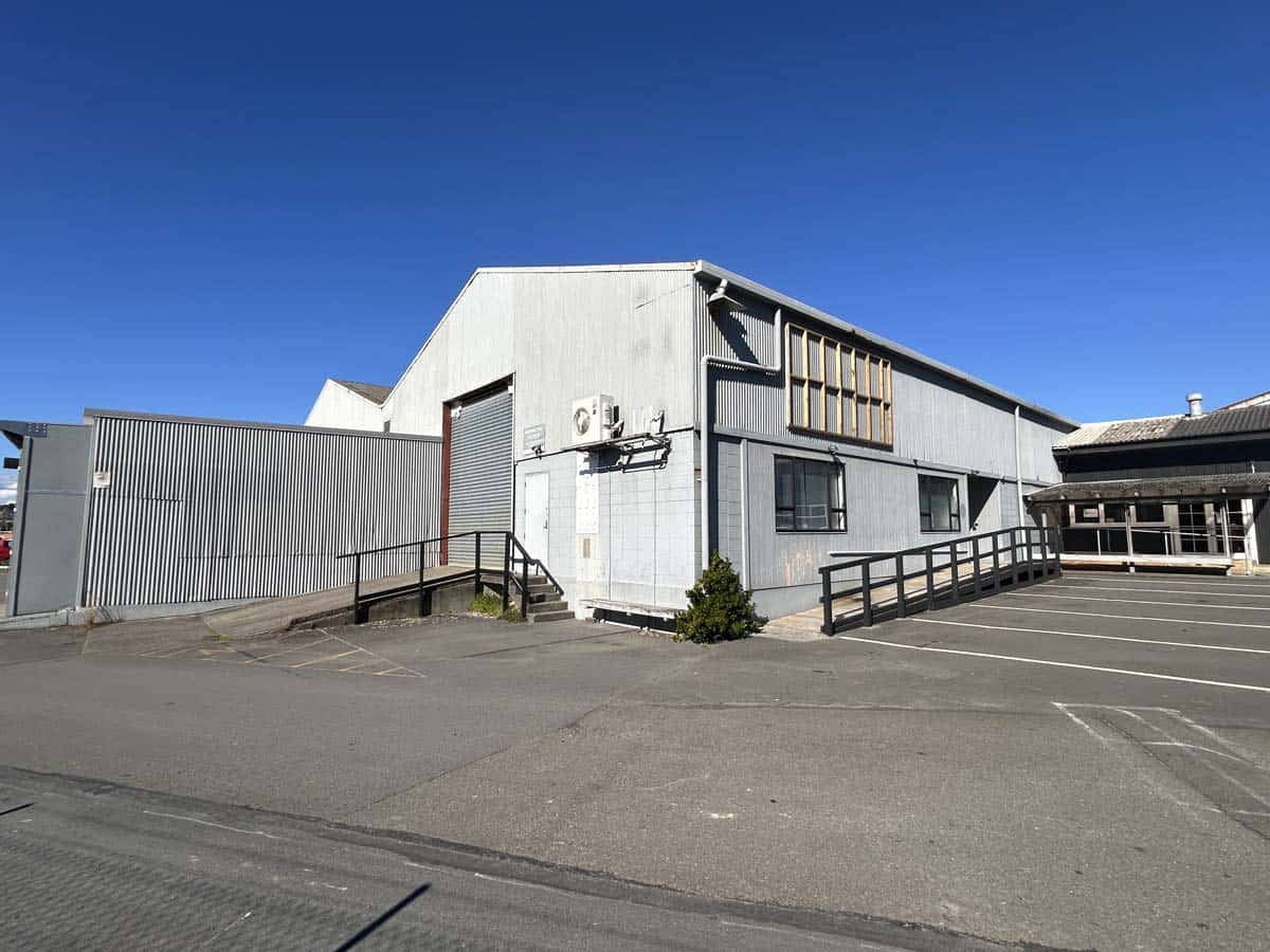 Modern industrial building with metal siding and ramp access in New Zealand.