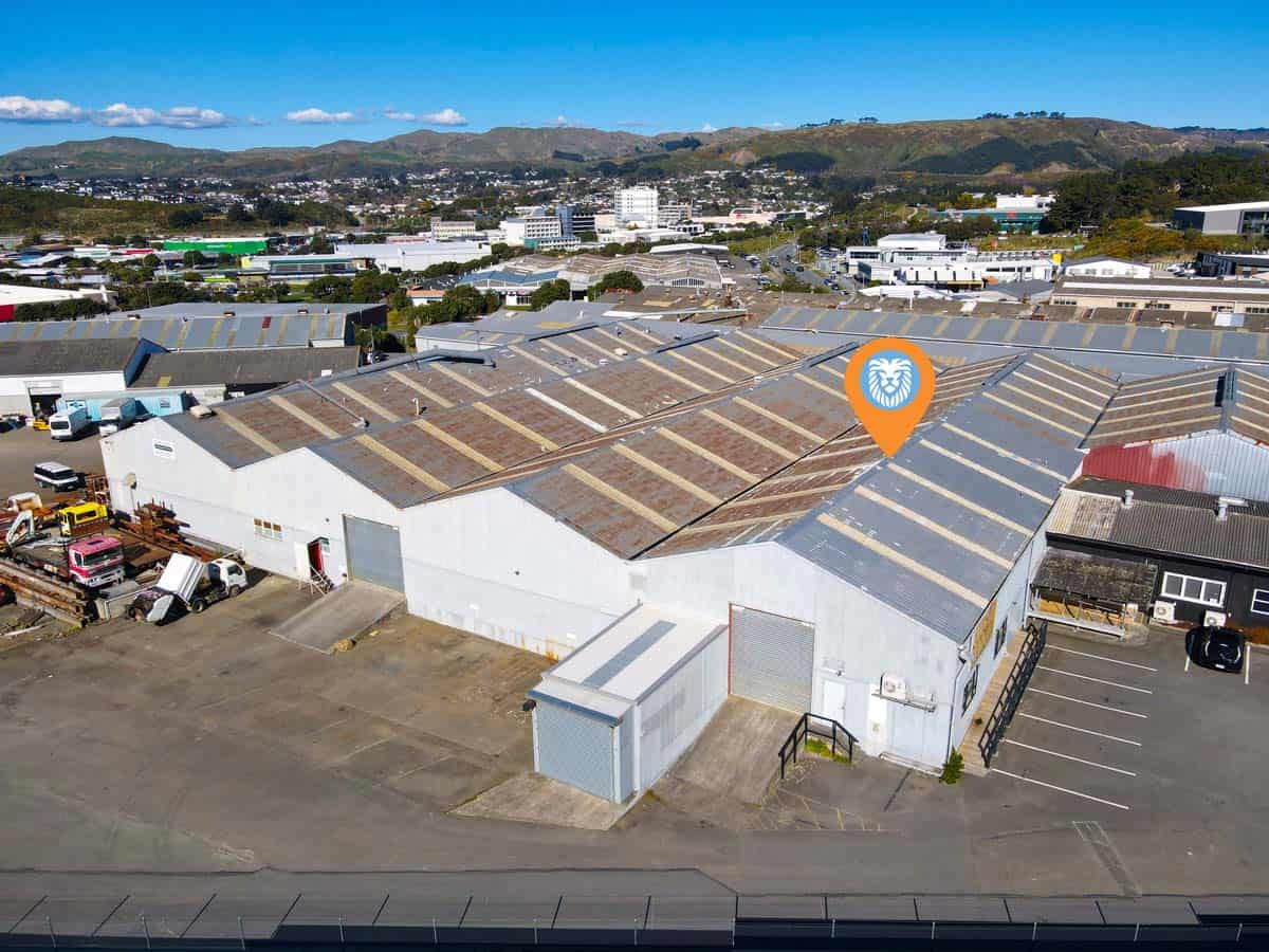 Aerial view of White Lion industrial warehouse with parking and surrounding buildings.