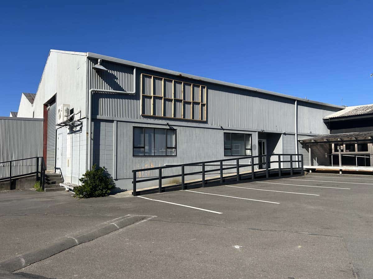 Modern industrial building at 8 Mohuia Crescent, featuring metal cladding and large windows.