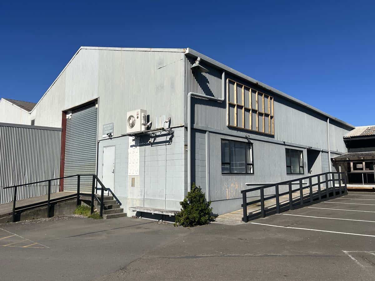 Modern industrial building at 8 Mohuia Crescent, featuring metal cladding and accessible ramps.