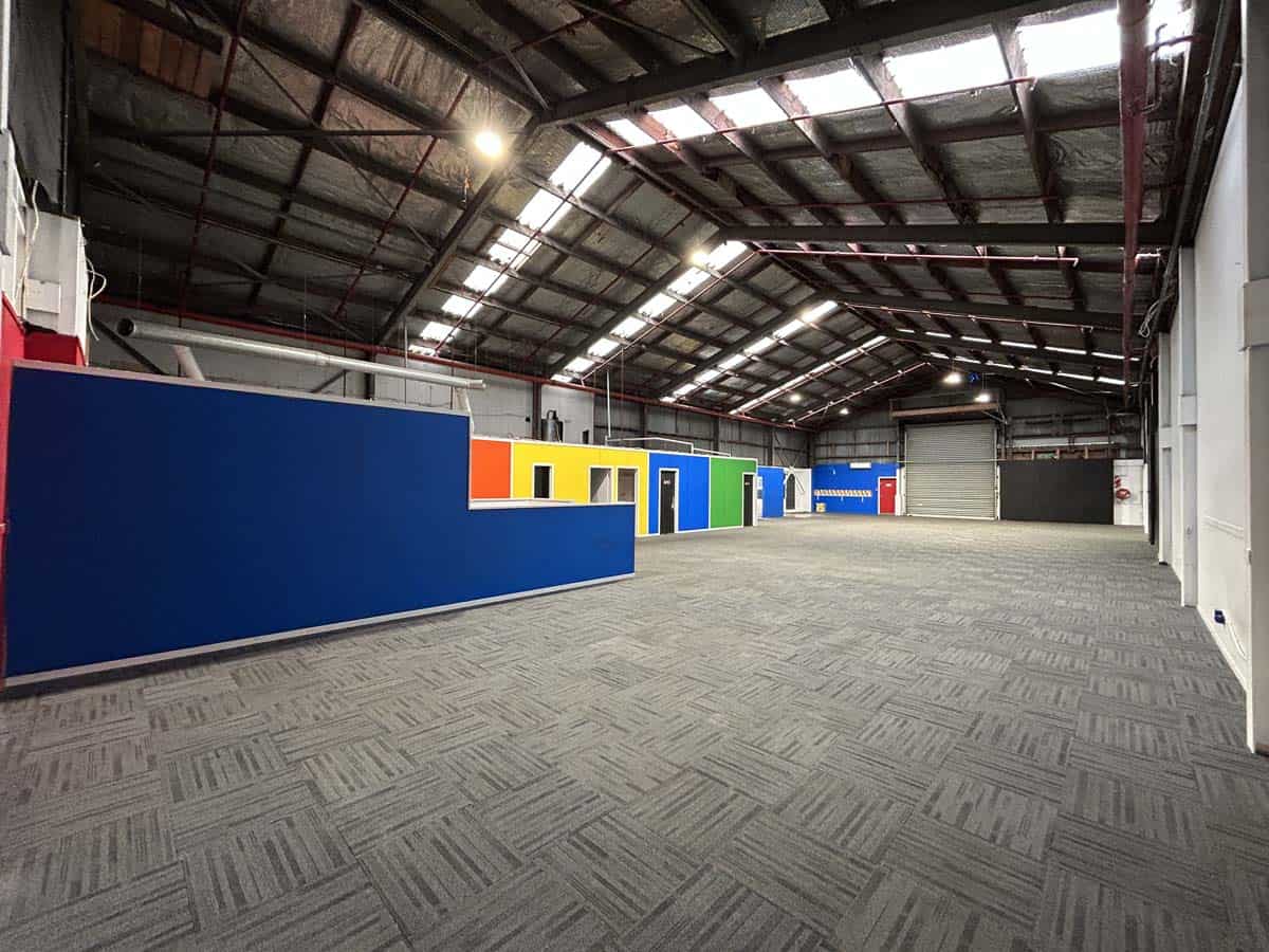 Spacious industrial warehouse with colorful walls and high ceilings at 8 Mohuia Crescent 1.
