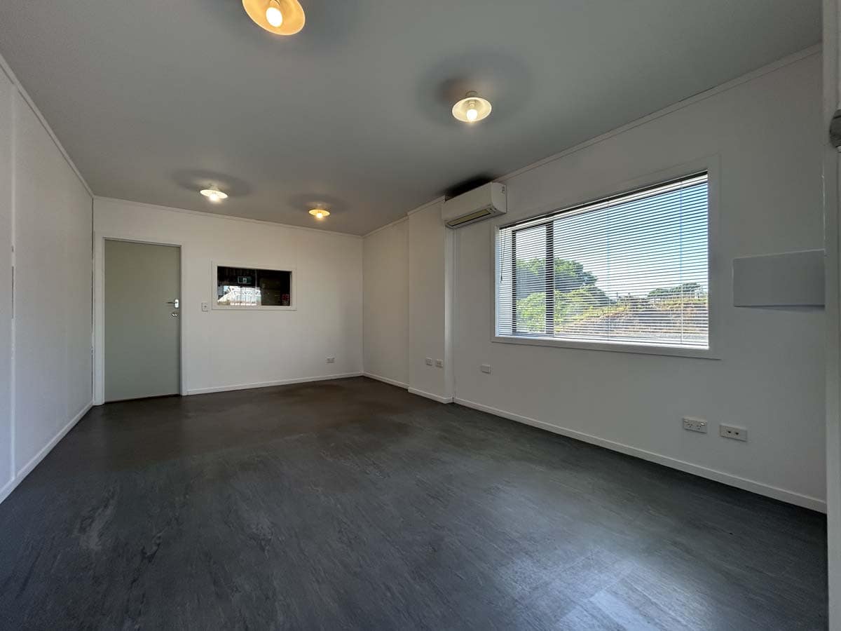 Spacious room with large window and modern lighting at 107 Corbett Road.