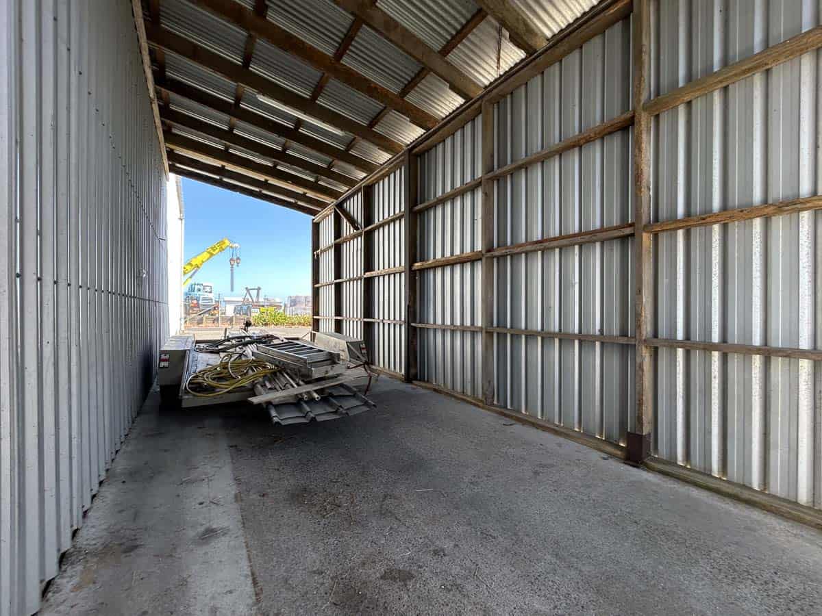 Construction site at 107 Corbett Road with metal framework and building materials.