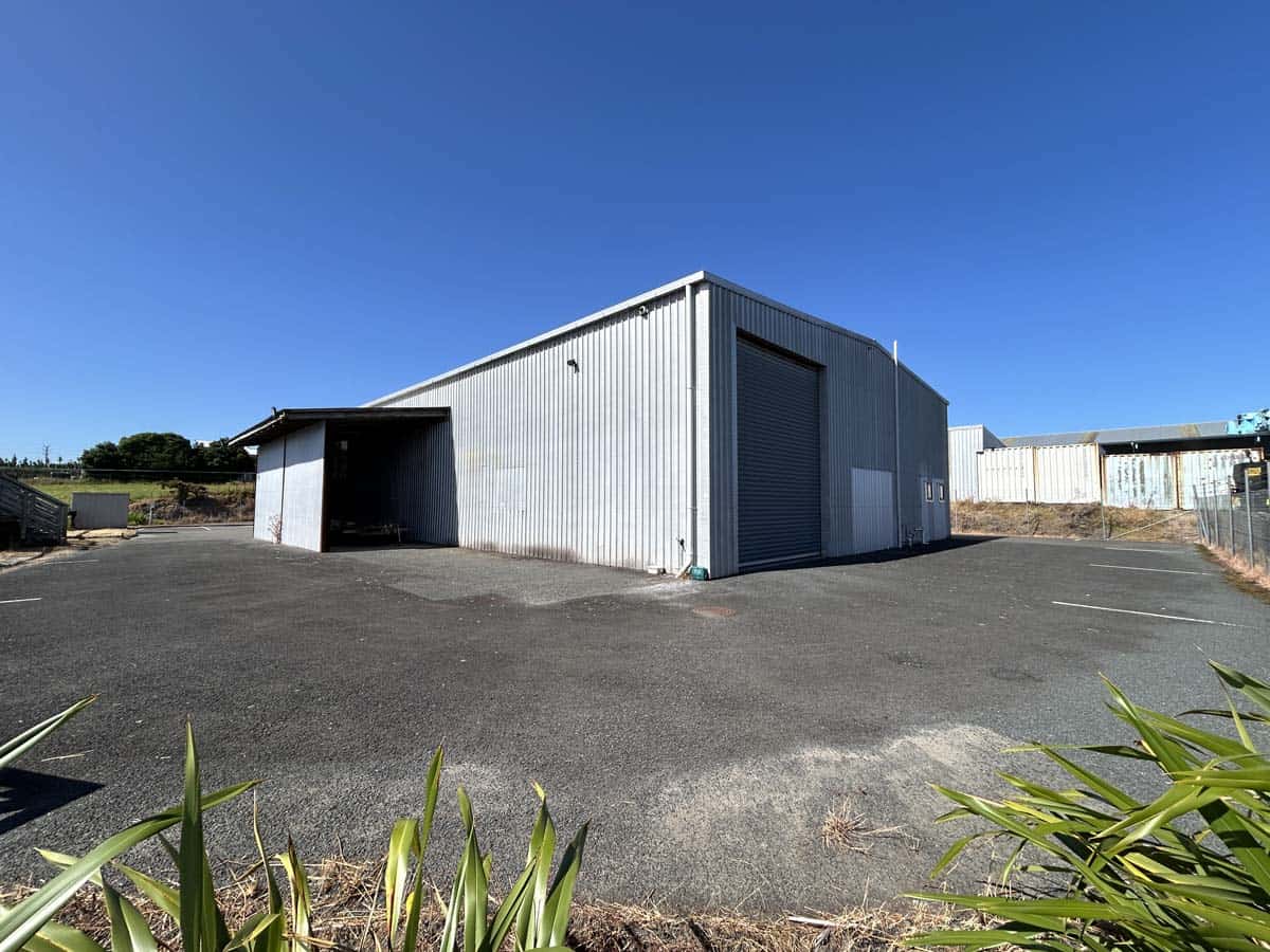 Industrial warehouse at 107 Corbett Road, featuring metal construction and large roller doors.