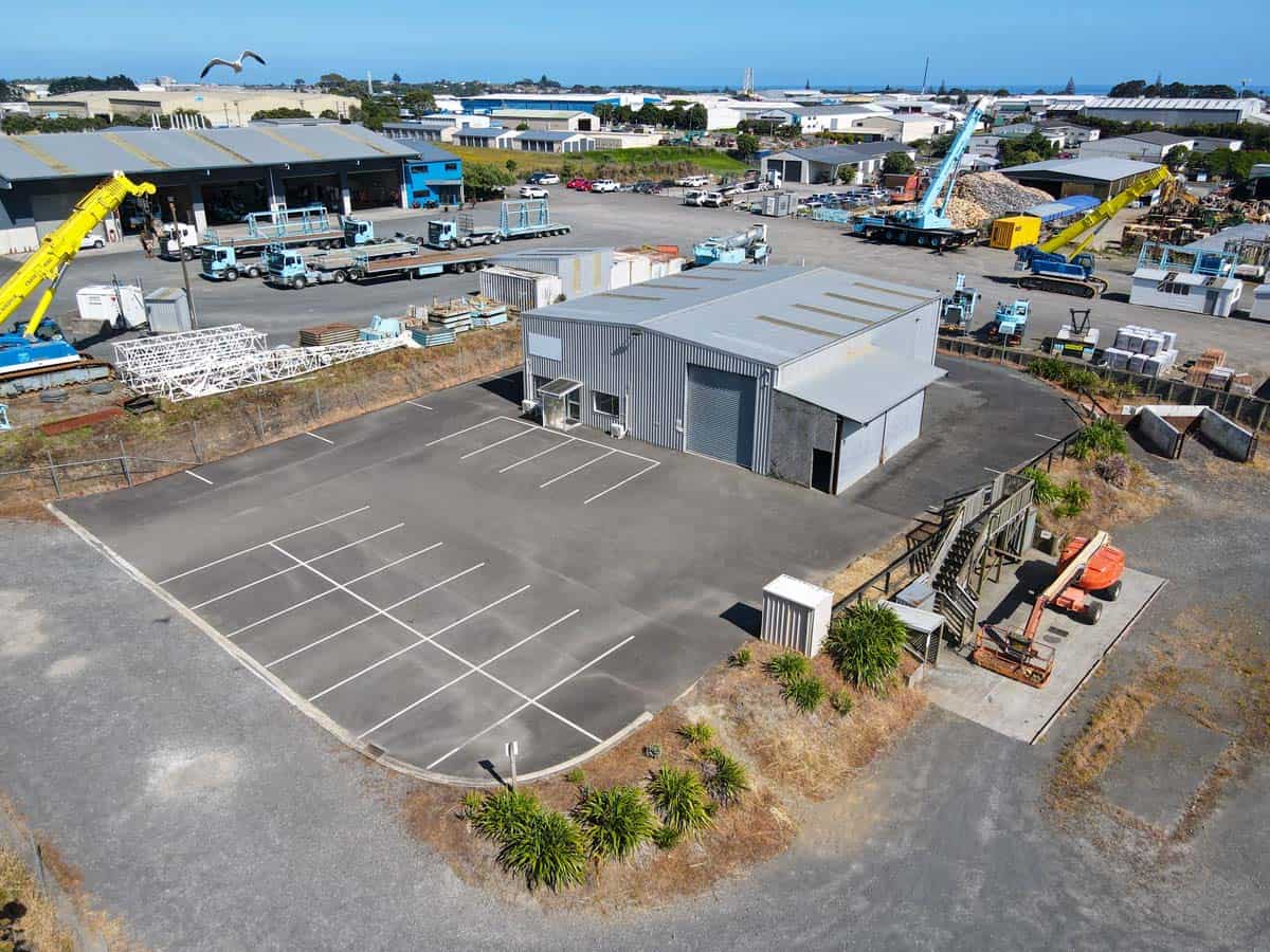 Modern industrial warehouse at 107 Corbett Road with parking area.