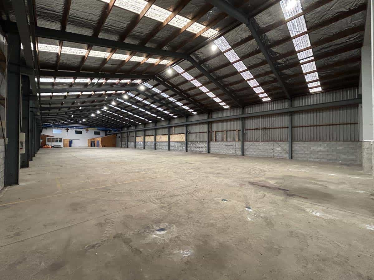 Large industrial warehouse space with high ceilings and ample natural light.