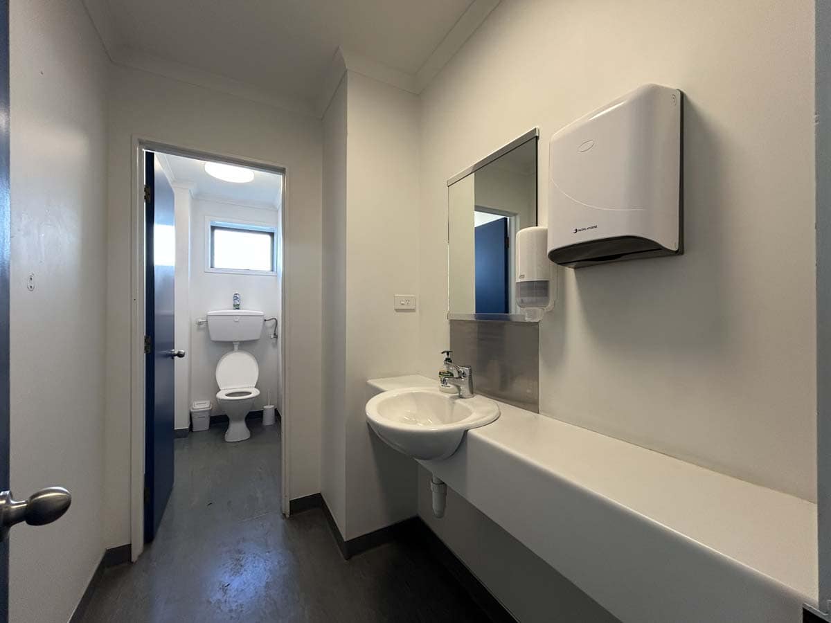 Clean and functional bathroom with sink, mirror, and toilet at 107 De Havilland Drive.