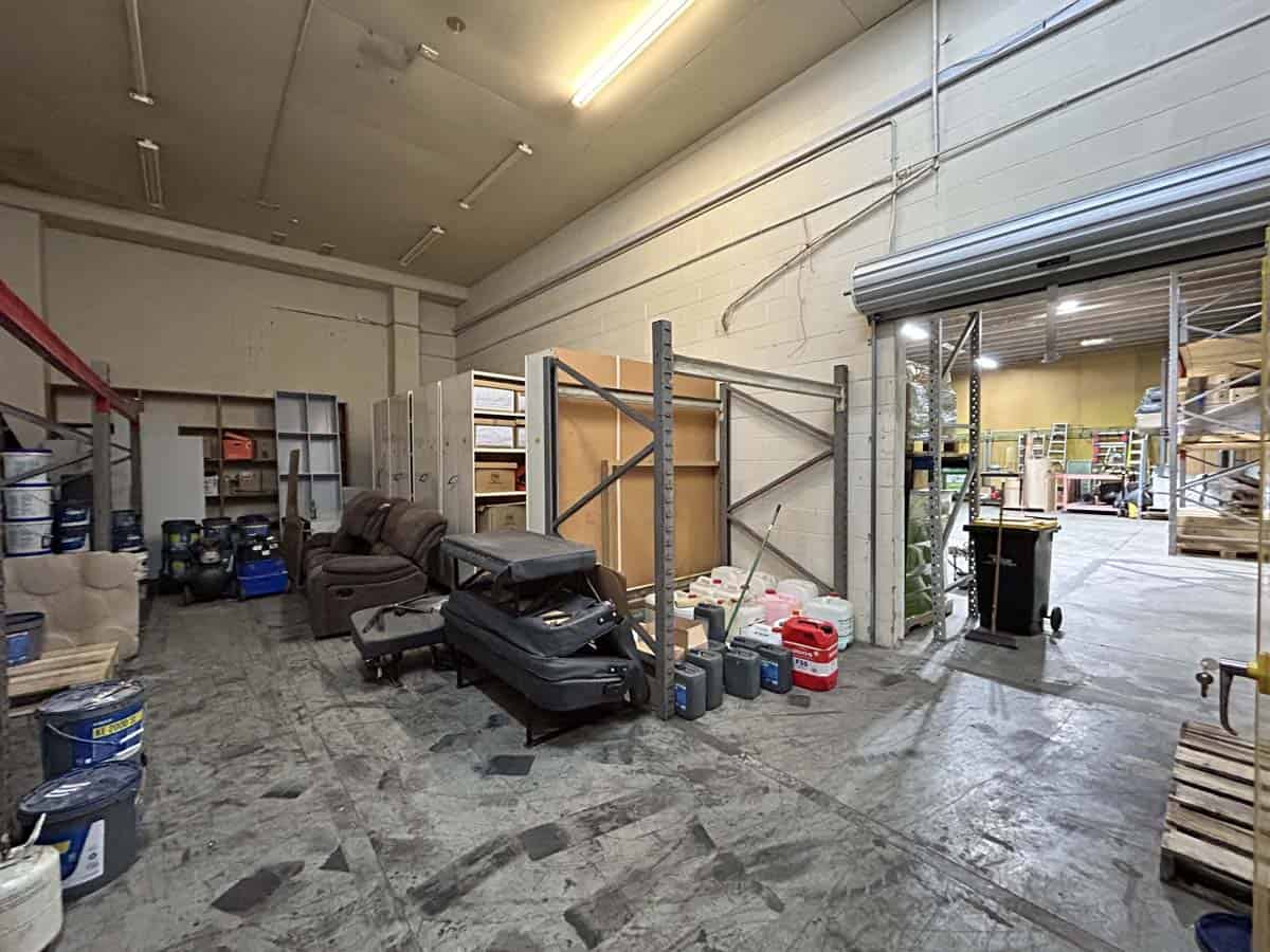 Interior of a warehouse with shelves, furniture, and storage items at 11-13 Lower Tyers Road.
