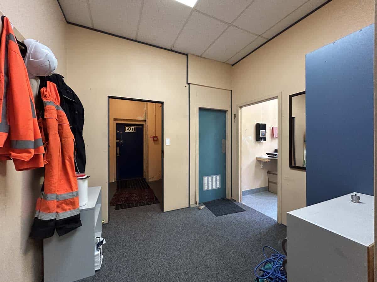 Bright office space with safety gear and a sink area for staff at 11-13 Lower Tyers Road.