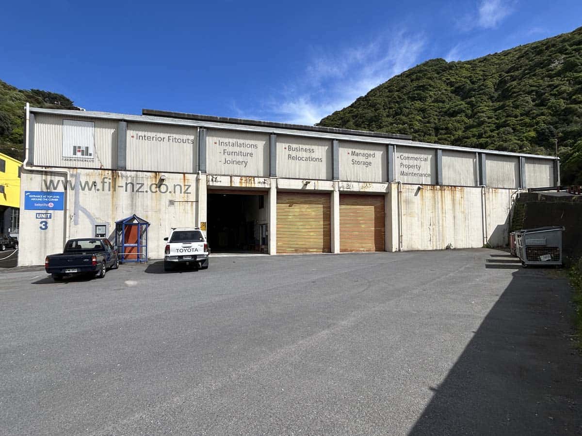 Industrial warehouse with signage for interior fitouts, furniture, and business relocations.