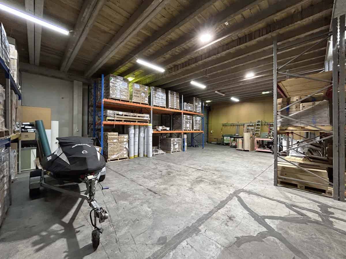 Interior of a warehouse with shelving, storage racks, and equipment at 11-13 Lower Tyers Road.