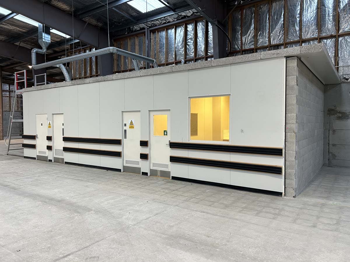 Modern industrial building with secure doors and ventilation systems.