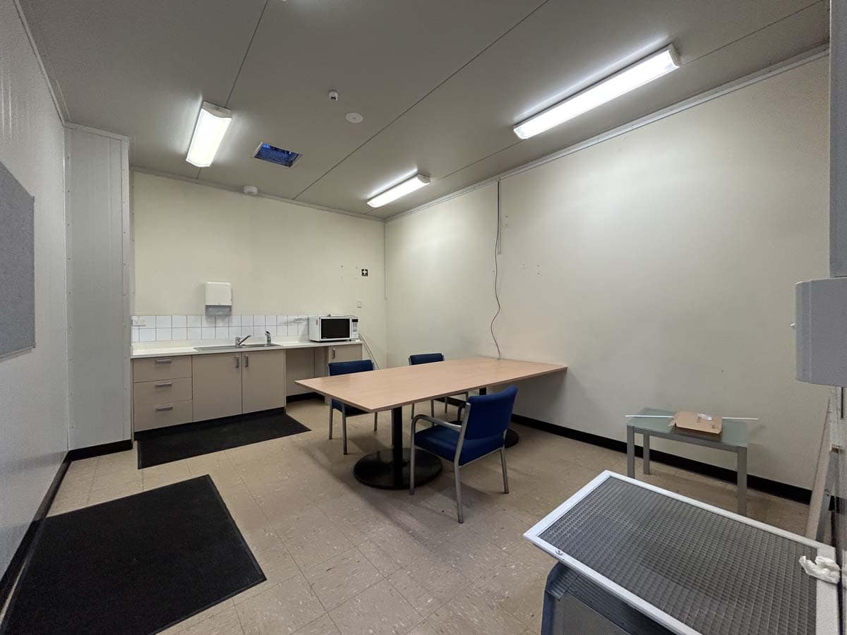 Interior of White Lion commercial space at 14 Tyers Road, featuring a meeting area with table and ch.