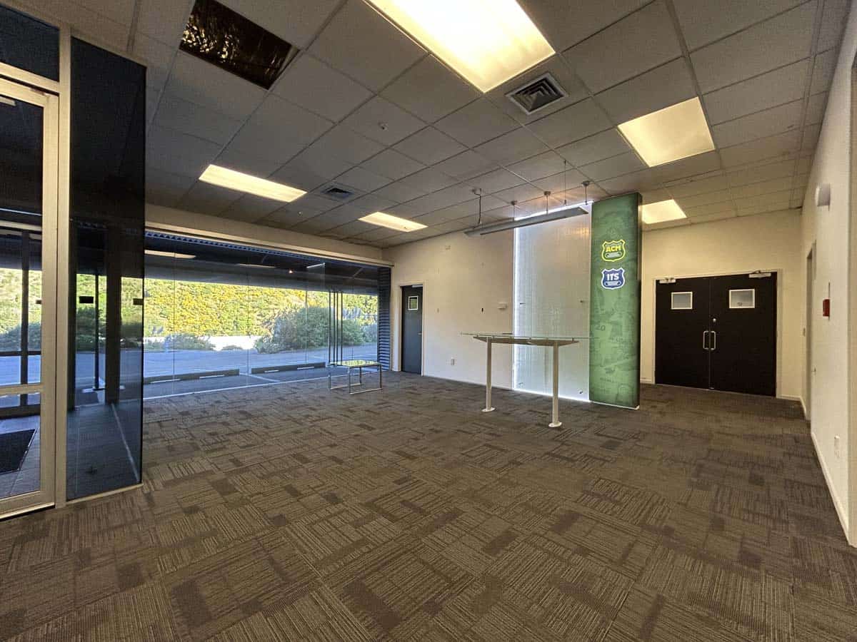 Spacious commercial office space with large windows and modern lighting.