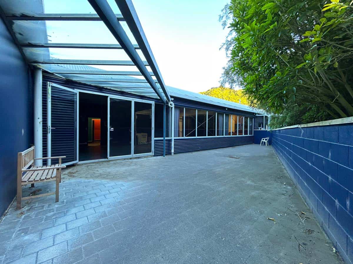 Spacious outdoor area featuring glass sliding doors and lush greenery at 14 Tyers Road.