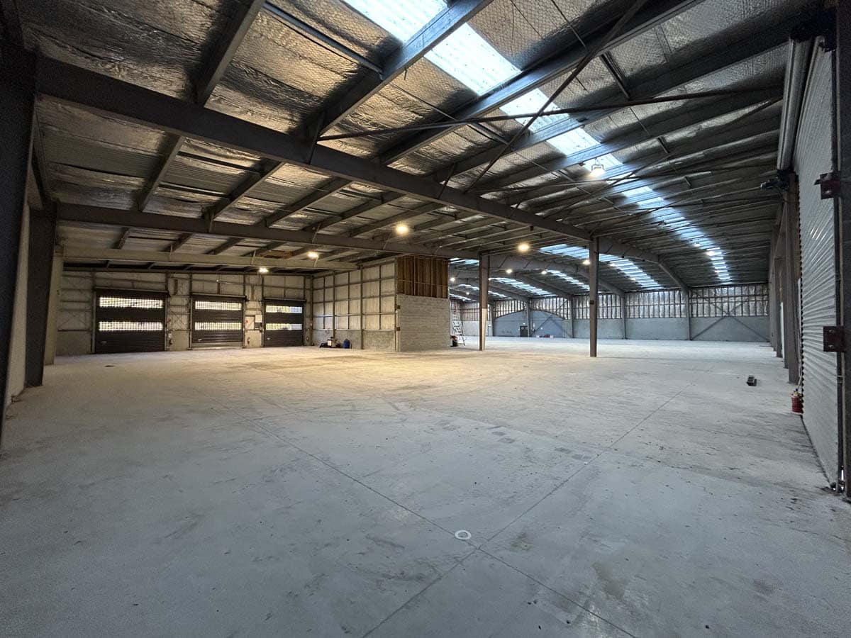 Spacious industrial warehouse with high ceilings and natural light at 14 Tyers Road.