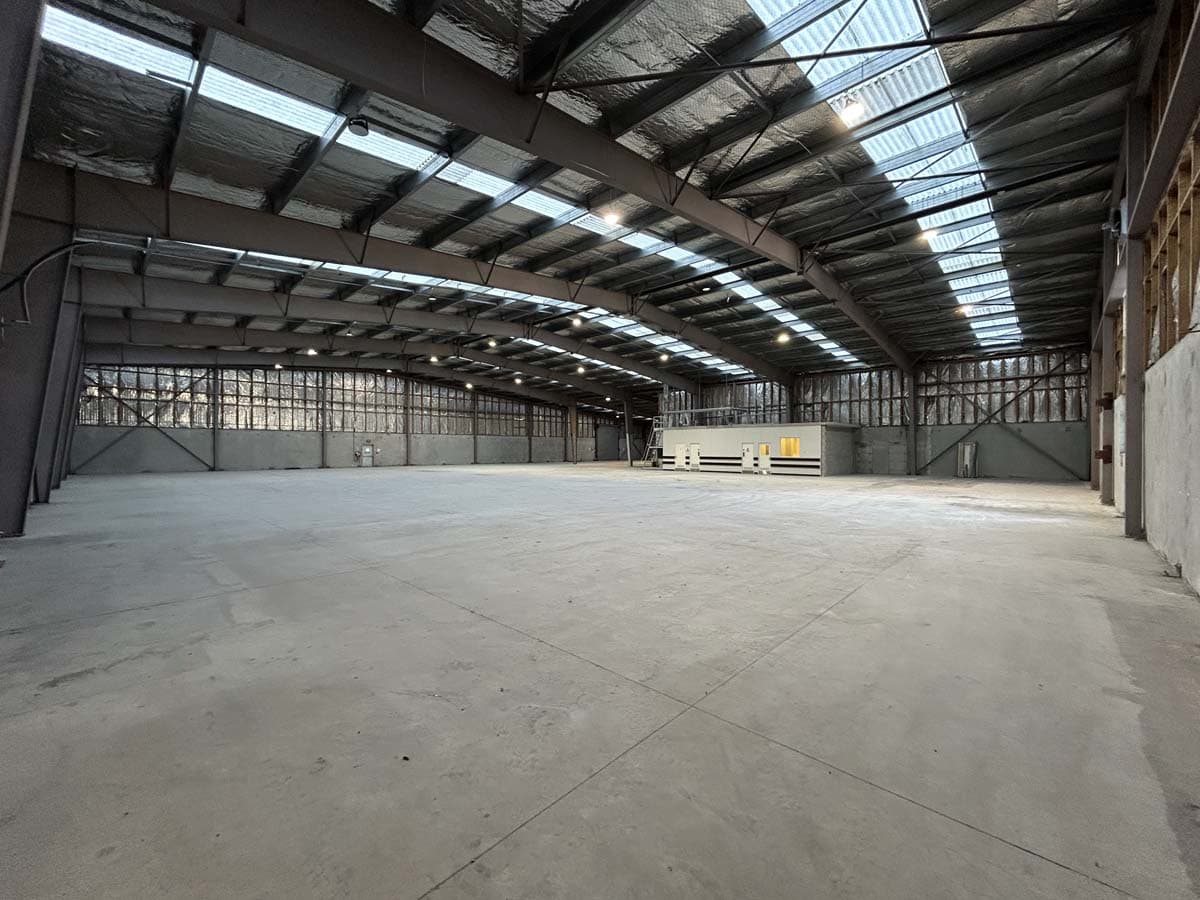 Large industrial warehouse with high ceilings and ample natural light.