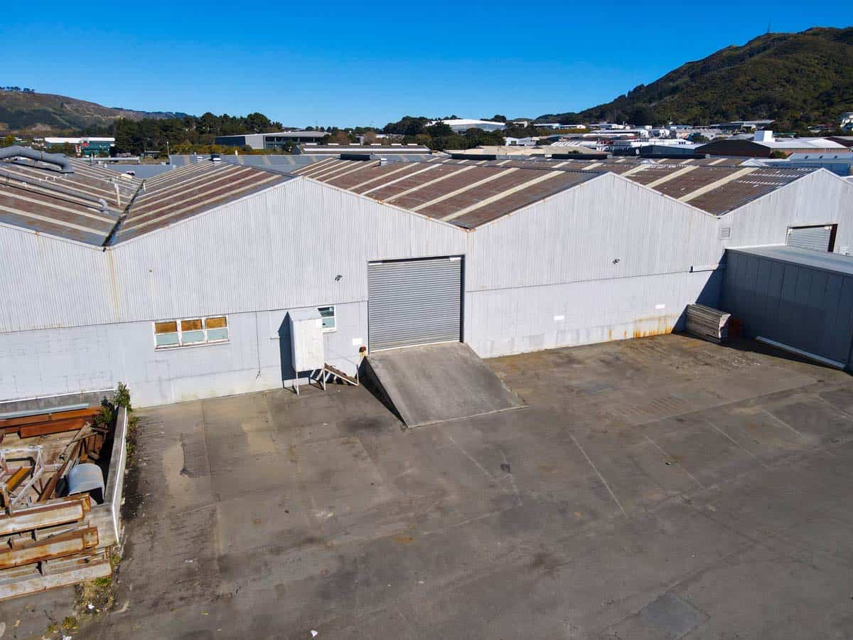 Large industrial warehouse with metal roofing and loading dock at 8 Mohuia Crescent 2.