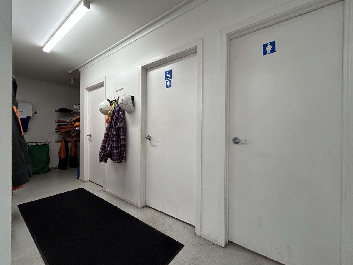 Accessible and standard restroom doors at 211 Connett Road, featuring clear signage.