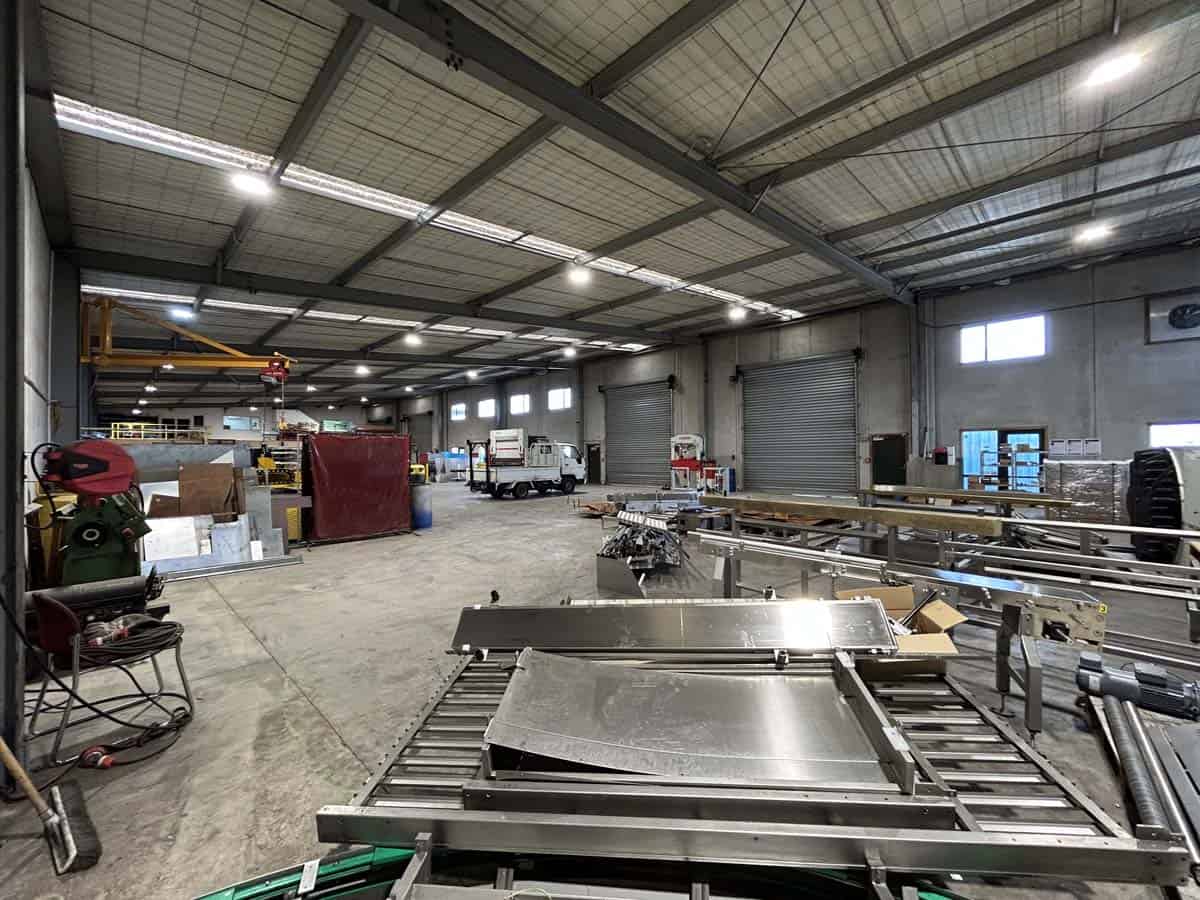 Industrial workshop with metal fabrication equipment and tools.