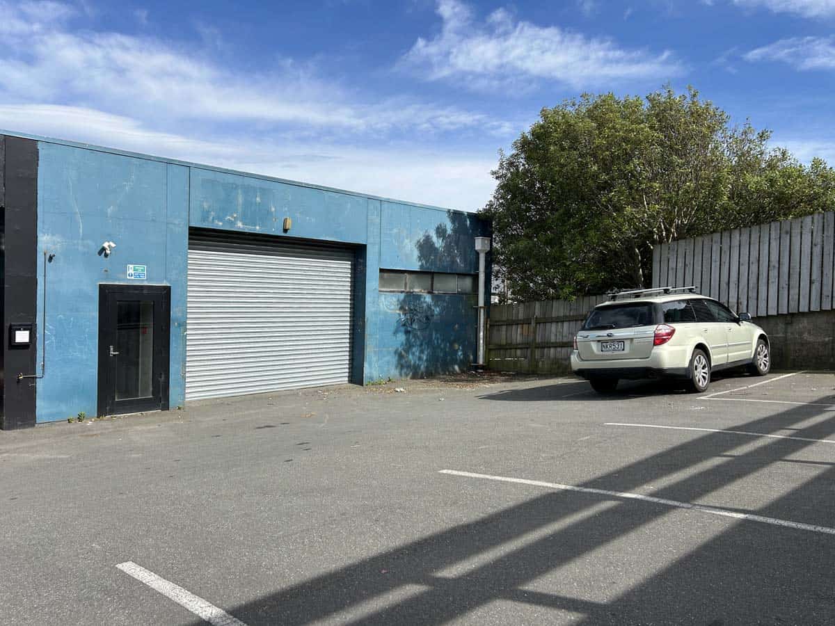 Industrial building with blue facade and parking area at 31 Johnsonville Road.
