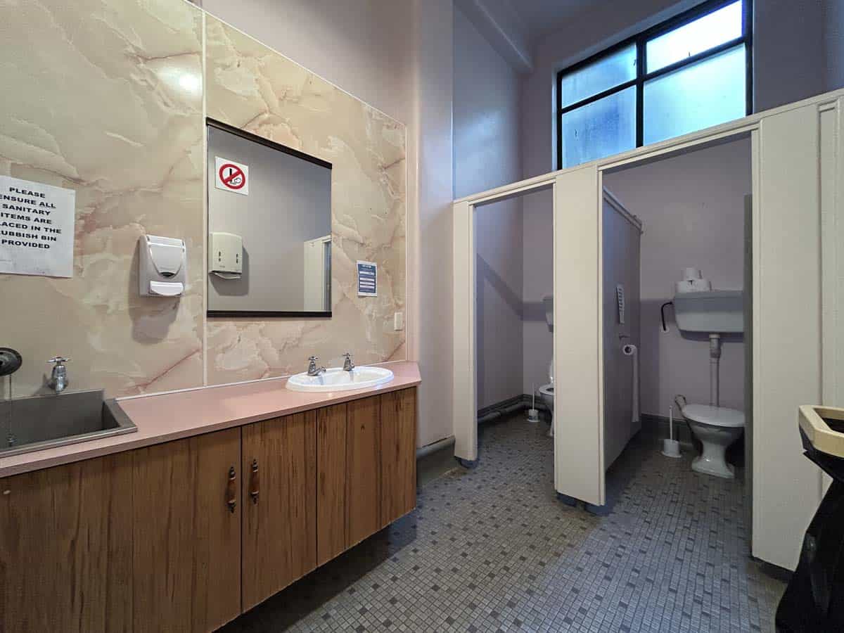 Public restroom with sink and toilet facilities.