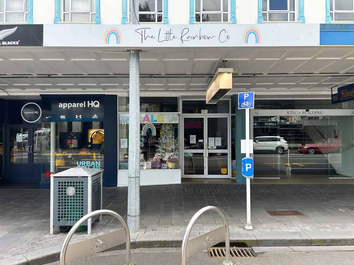 Exterior view of White Lion store at 38 Devon Street West, featuring storefront signage and parking.