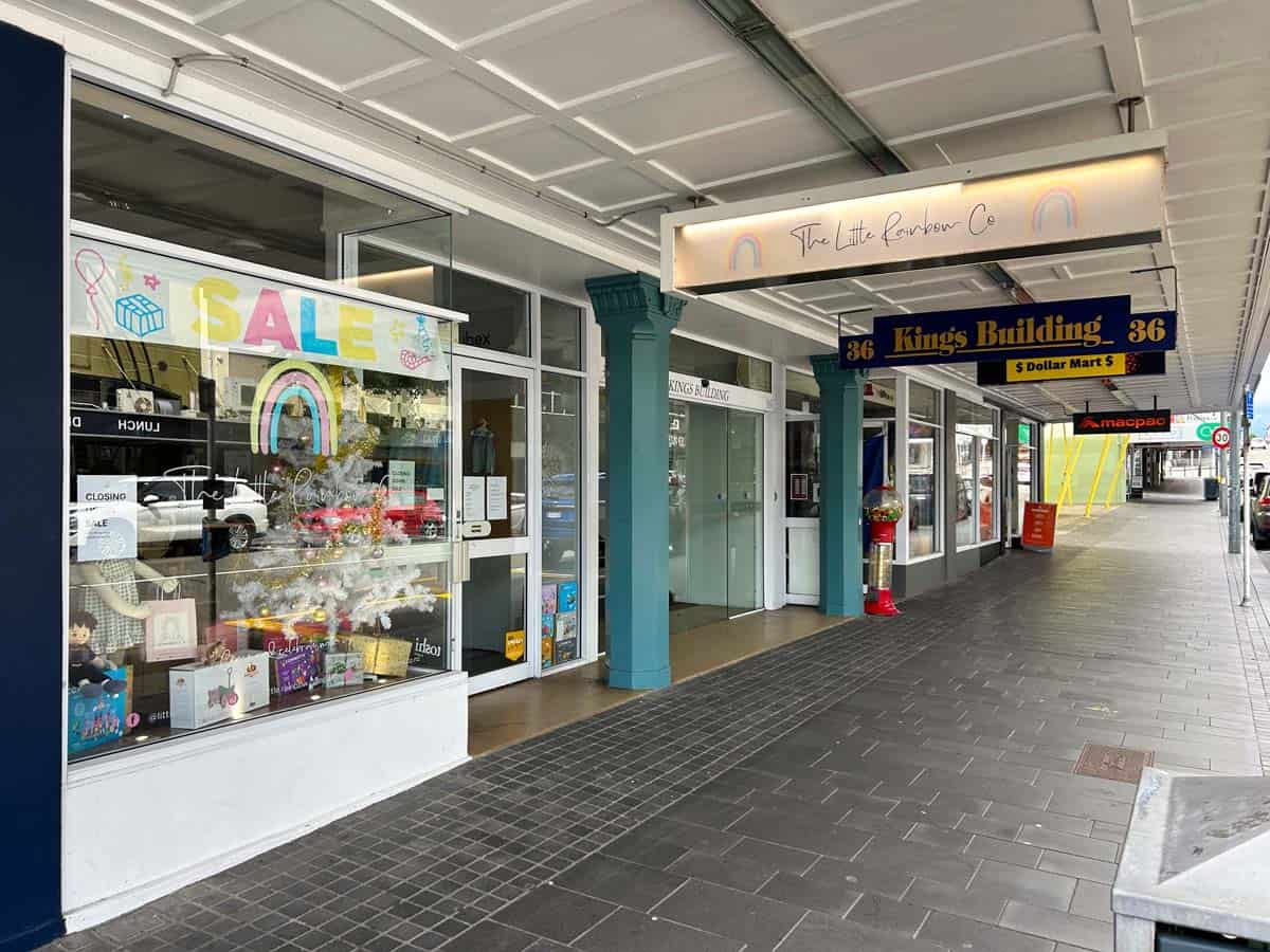 Exterior view of White Lion store with sale sign and storefront details.