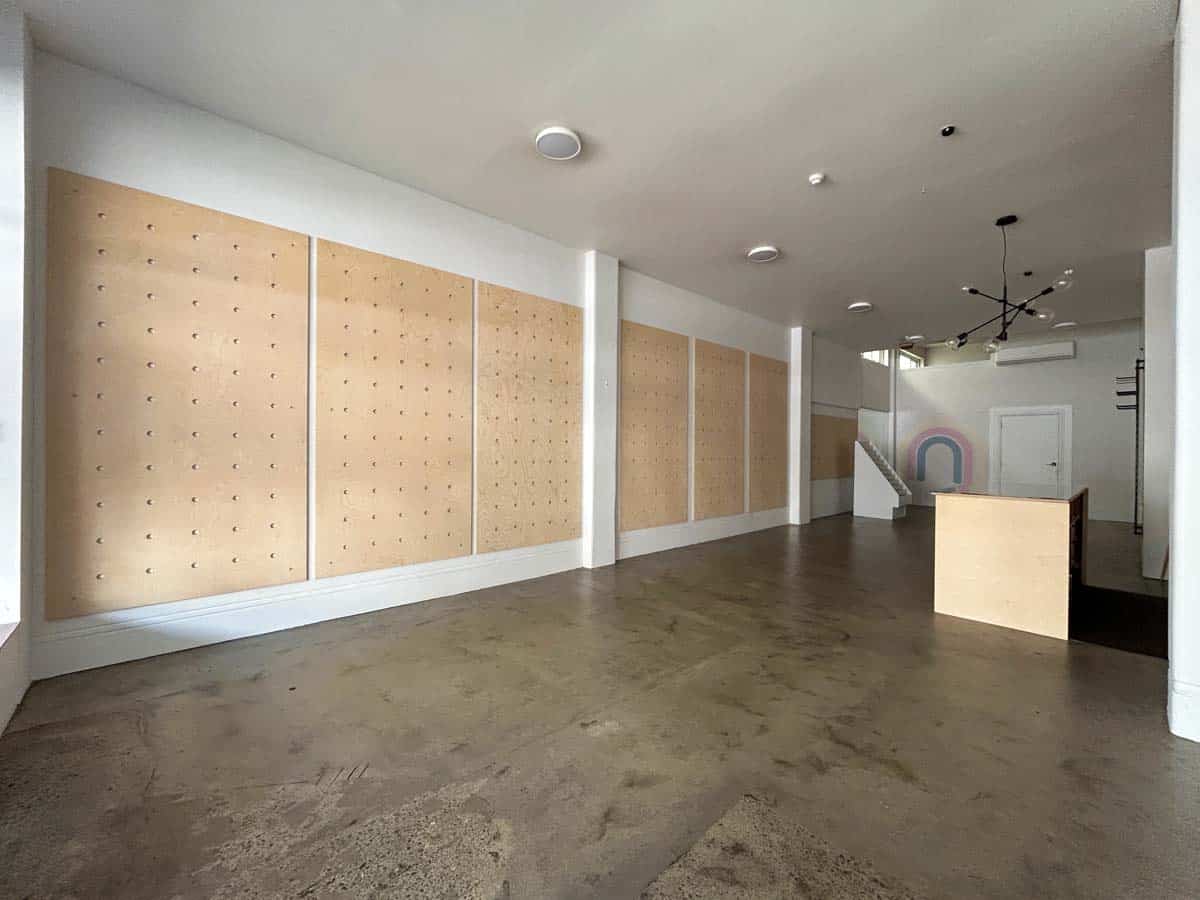 Modern White Lion space with wooden pegboards and minimalist design.