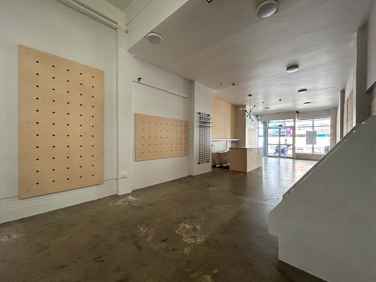 Bright retail store interior with display boards at 38 Devon Street West.