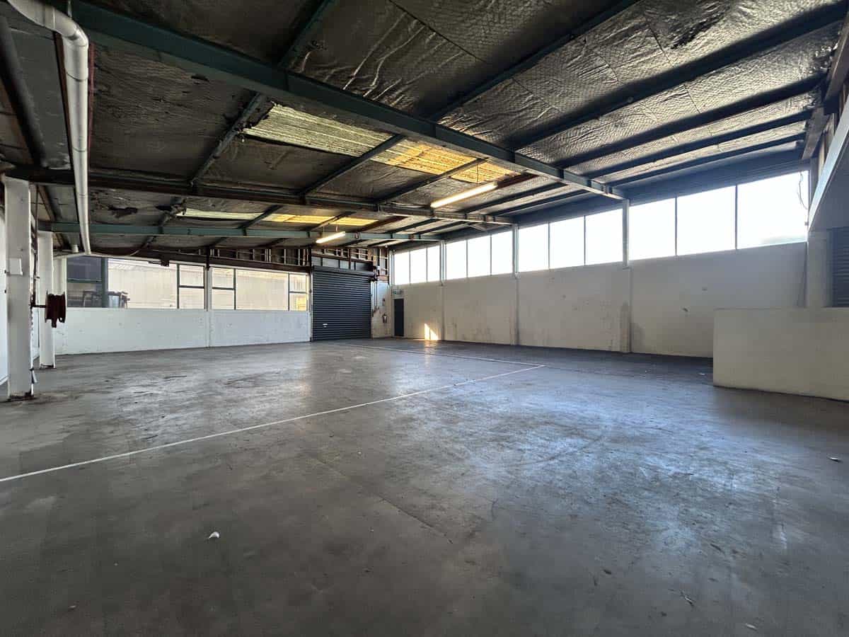 Spacious industrial warehouse at 45 Waione Street with high ceilings and large windows.
