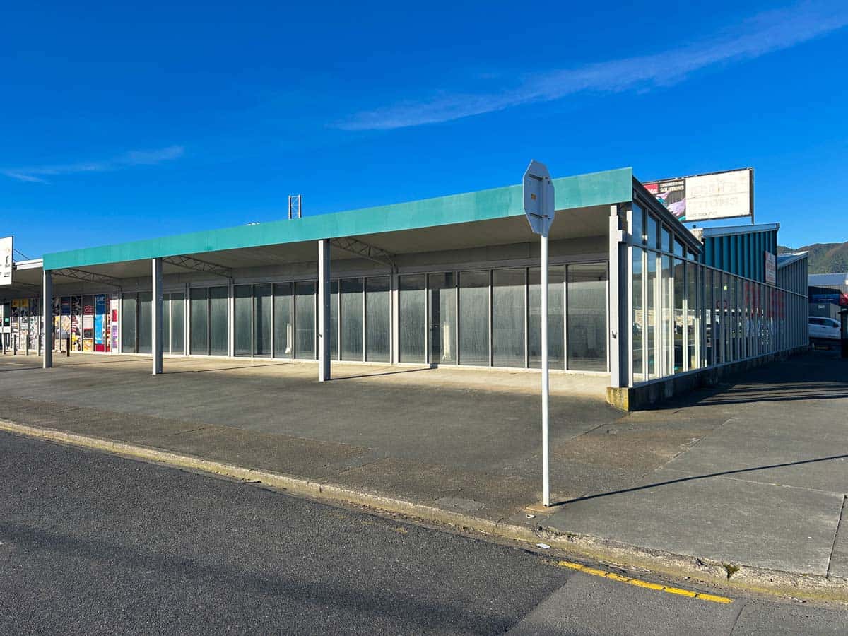 Modern commercial building at 45 Waione Street with glass facade and blue sky.